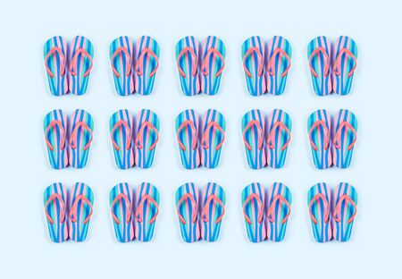 Summer colorful flip flop pattern on blue background. Beach vacation conceptの写真素材