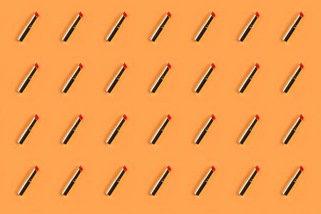 Red golden lipstick pattern on peach orange backgroundの写真素材