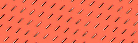 Red golden lipstick pattern on peach orange backgroundの写真素材