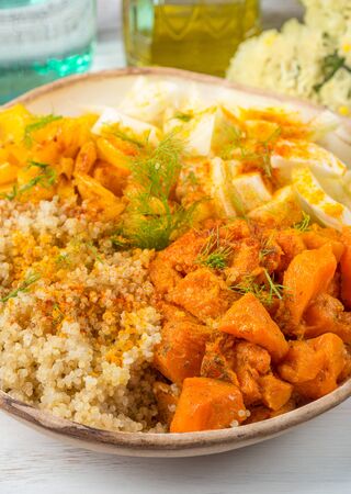 Vegan quinoa bowl with baked spiced pumpkin, fennel, bell pepper and turmeric. Healthy gluten free lunch or dinnerの写真素材