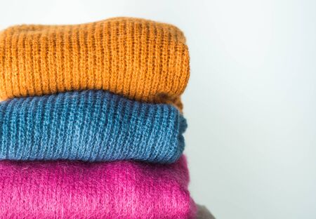 Pile of colorful woolen sweaters. Fall, winter fashion colorsの写真素材