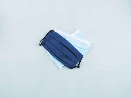 New normal essentials - protective face masks, medical and textile. Flat lay on pastel blue backgroundの写真素材