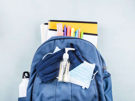 New school set after Covid quarantine including backpack with stationery, books and protective face masks, sanitizerの写真素材