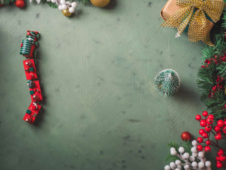 Christmas festive dark earthy green background with toy wooden vintage train and small tree. Moody frame flat layの写真素材