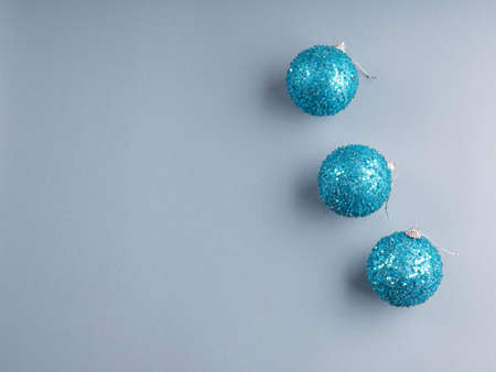 Christmas minimal festive gray background with blue sparkling disco baubles. New year backdropの写真素材