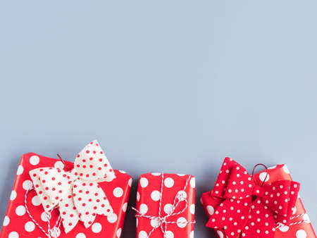 Vintage style gifts stack wrapped in polka dot paper with bows on blue background. Christmas, Valentines dayの写真素材