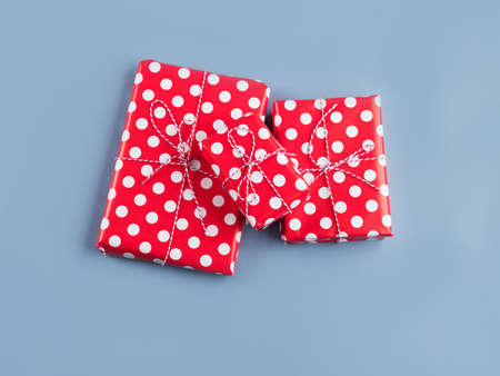 Vintage style gifts stack wrapped in polka dot paper with bows on blue background. Christmas,...