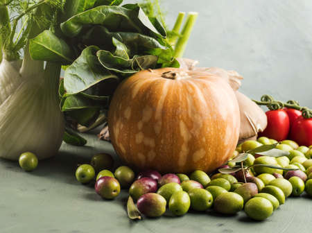 Green background with raw organic vegetable, fruit. Autumn, winter veggies concept, healthy food.の写真素材