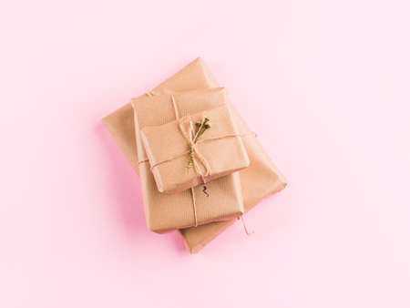 Stack of wrapped zero waste gift boxes on pink background