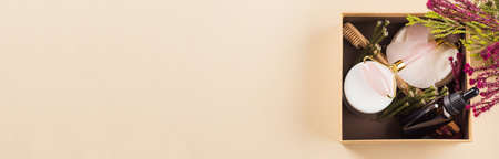 Zero waste beauty skin care gift box with flowers. Guasha, essential oil, bamboo toothbrushes. Web bannerの写真素材