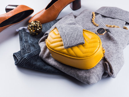 Fashion outfit with gray woolen turtle neck and illuminated yellow handbag clutch. Lady winter autumn style in trendy colors. Winter new year saleの写真素材