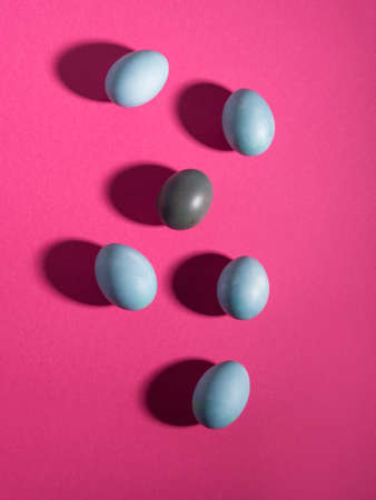 Blue easter hen eggs on dark pink background.の写真素材