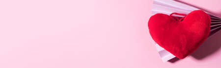 Trendy Valentines day backgound with stuffed red heart and purple paper fan on pink. Love concept,...