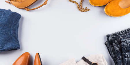 Fashion autumn winter lady outfit items frame flat lay. Trendy yellow, blue, gray clothes and...