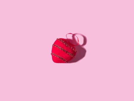 Trendy Valentines day backgound with stuffed red heart and hard shadow on pink. Love symbol concept