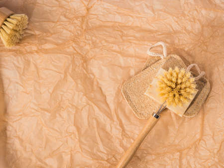 Zero waste natural dish washing kitchen home eco cleaning products - wooden brushes, loofah sponge, bio soap bar on neutral beige backgroundの写真素材