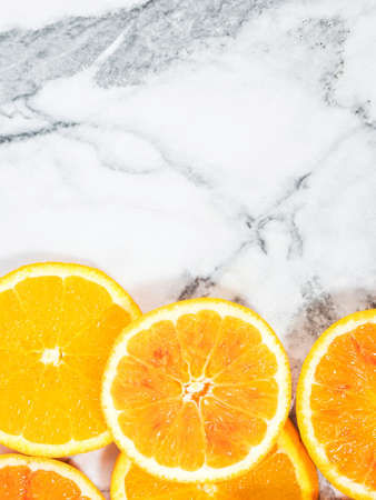 Colorful orange citrus slice fruit texture background on white marble tableの写真素材
