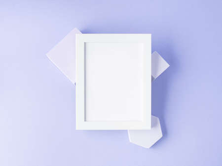 White empty frame for text on purple geometric cubes, flat lay