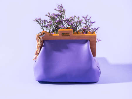 Purple leather fashion accessory handbag with violet flowersの写真素材
