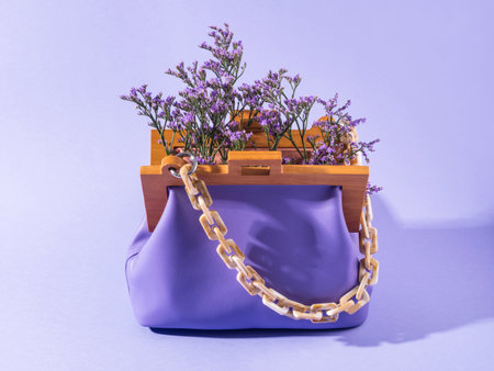 Purple leather fashion accessory handbag with violet flowersの写真素材