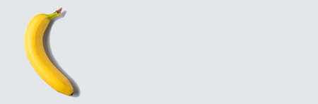 Banana fruit on gray background, web bannerの写真素材