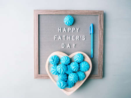 Happy fathers day greeting card with letter board and blue meringues