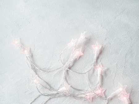 Light gray background with star shape Christmas lights string