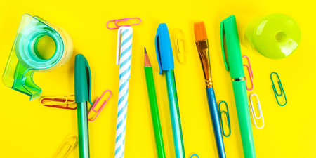 Back to school concept. Colorful writing tools on yellow backgroundの写真素材