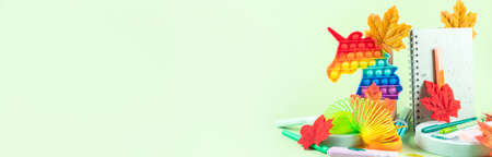 Colorful stationery copybooks set on green with autumn leaves. Back to schoolの写真素材