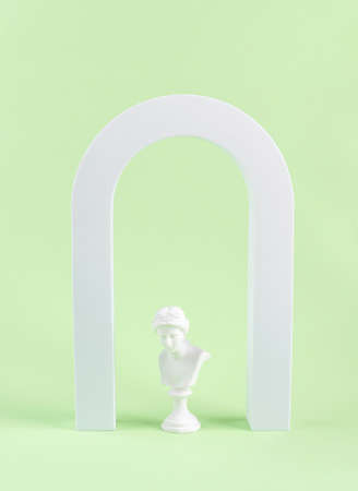 Geometric shape white arch and woman antique statue bust on green background