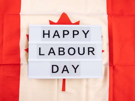 Happy Labour Day greetings on lightbox with canadian flagの写真素材