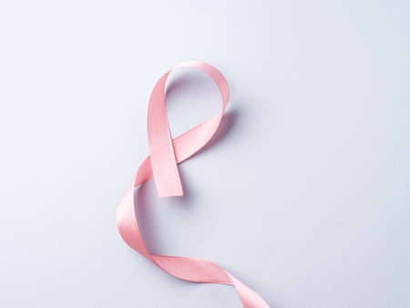 Breast cancer awareness pink ribbon symbol on gray backgroundの写真素材