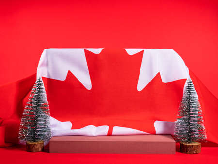 Christmas winter podium mockup on red background with canadian flagの写真素材