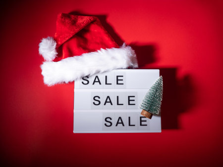 Christmas sale, boxing day lightbox on red with santa capの写真素材
