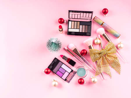 Christmas present with make up brushes, products on pinkの写真素材