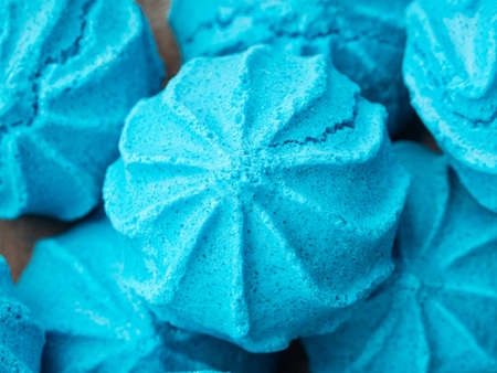 Macro closeup of dish with blue sweet meringues