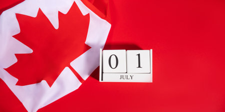 Canada Day, July 1 concept with Canadian flag on redの写真素材