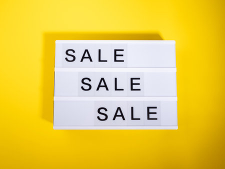 Sale store concept with lightbox text on yellow backgroundの写真素材