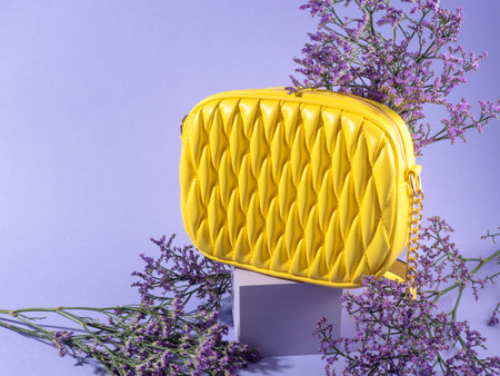 Yellow fashion lady handbag with purple flowers on monochrome backgroundの写真素材
