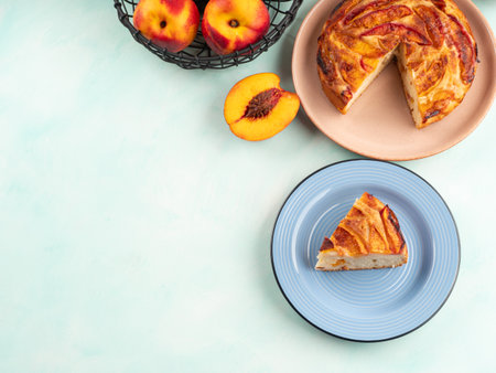 Vegan nectarine peach cake on turquoise table, summer treatの写真素材