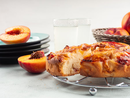 Vegan nectarine peach cake on turquoise table, summer treatの写真素材