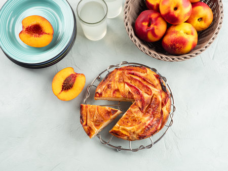 Vegan nectarine peach cake on turquoise table, summer treatの写真素材