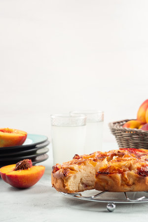 Vegan nectarine peach cake on turquoise table, summer treatの写真素材