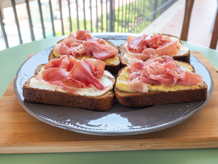 Open rye bread sandwich with ham and avocado cashew spreadの写真素材