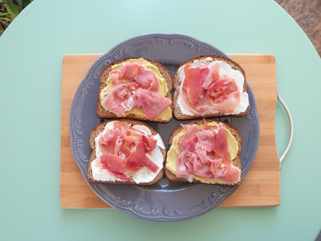 Open rye bread sandwich with ham and avocado cashew spreadの写真素材