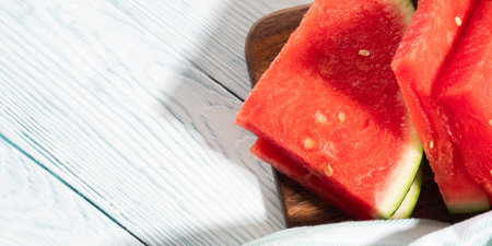 Seedless watermelon slices on wooden background, summer fruitの写真素材