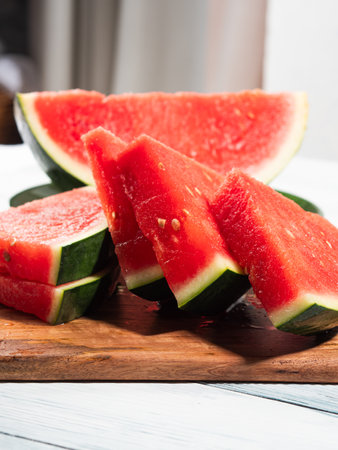 Watermelon slices on wooden cutting board, summer fruitの写真素材