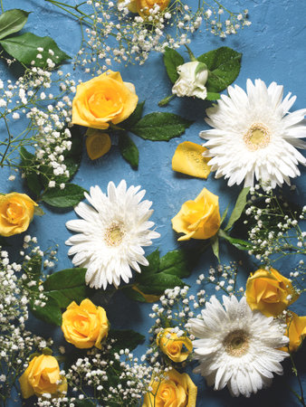 Floral background with yellow and white flowers on blueの写真素材
