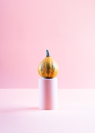Pumpkin autumn halloween thanksgiving symbol displayed on geometric podiumの写真素材
