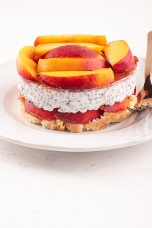 Overnight chia pudding dessert with greek yogurt, peaches and jamの写真素材